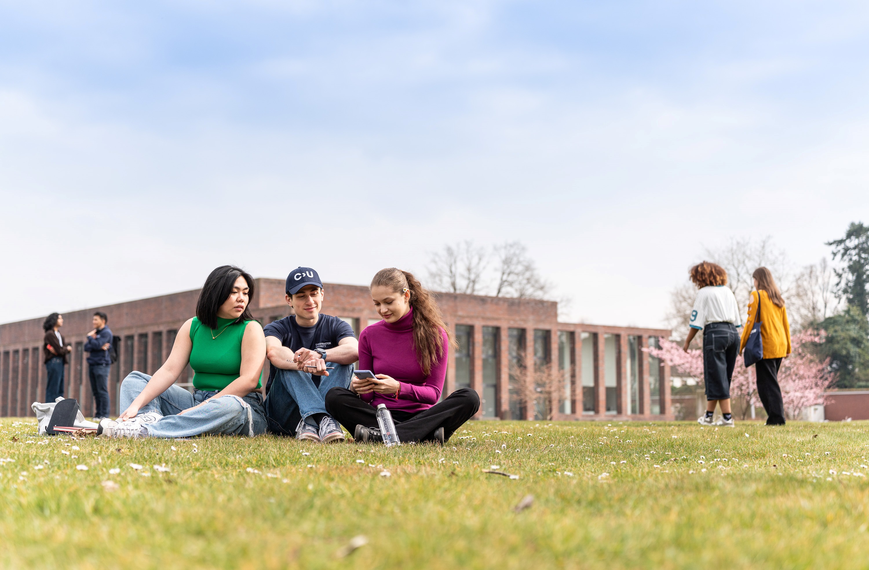 Students sitting in front of the Sports and Convention Center