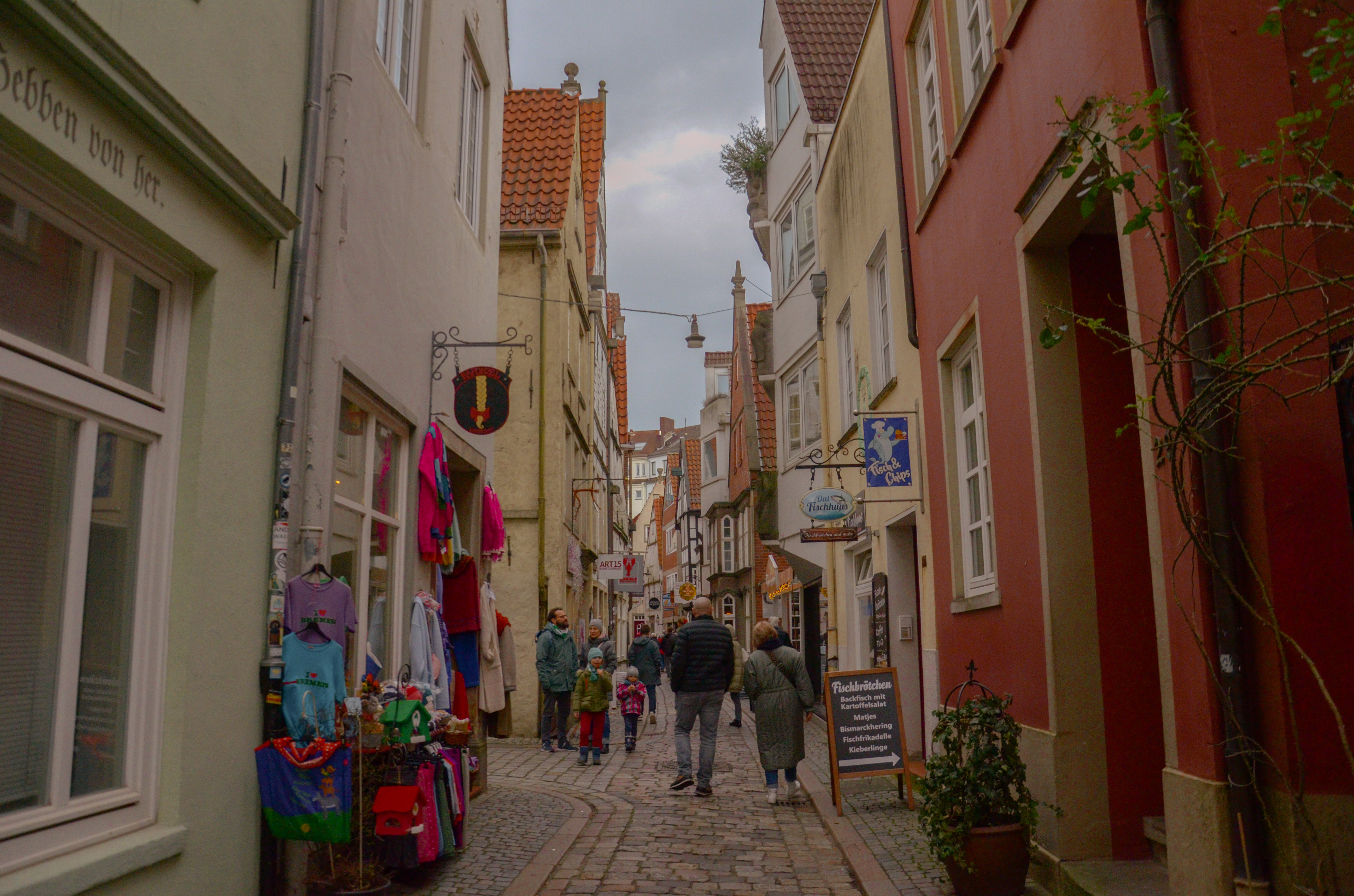 A cobblestone street with visitors in the Schnoor Quarter