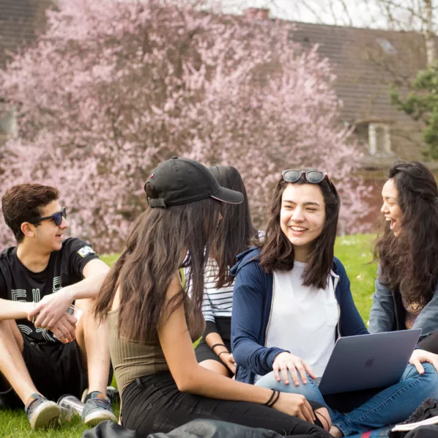 students sitting in the gras