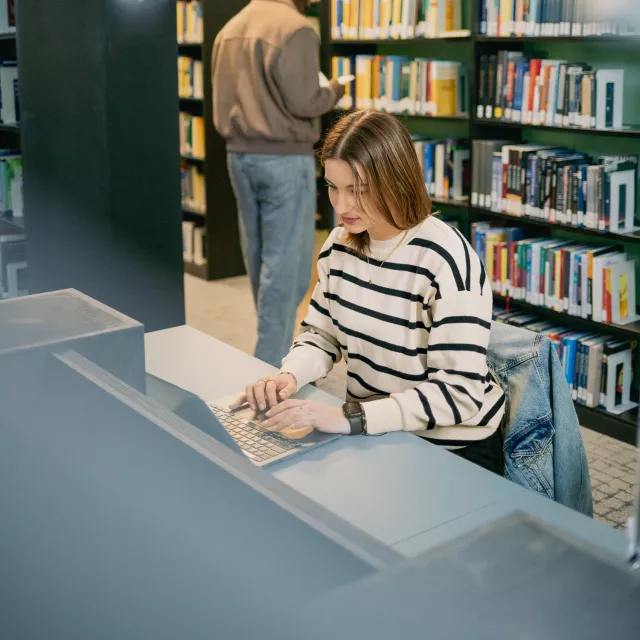 Student typing on a laptop